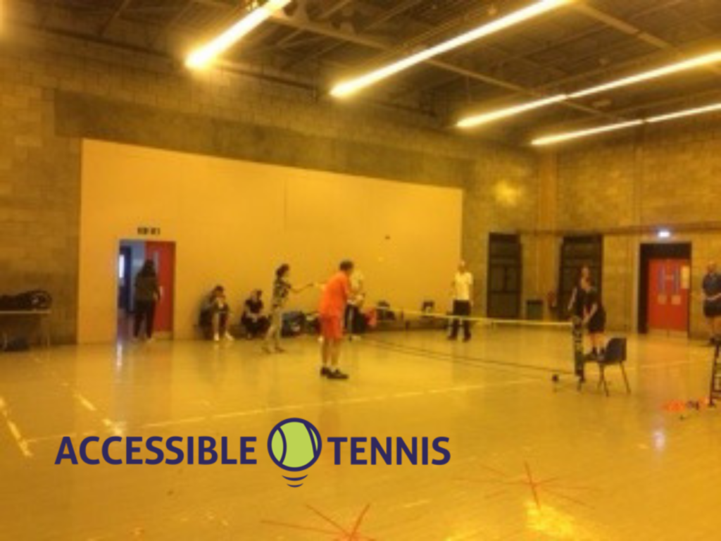 Tennis Players inside the community centre with the slight yellow of the strip lights above